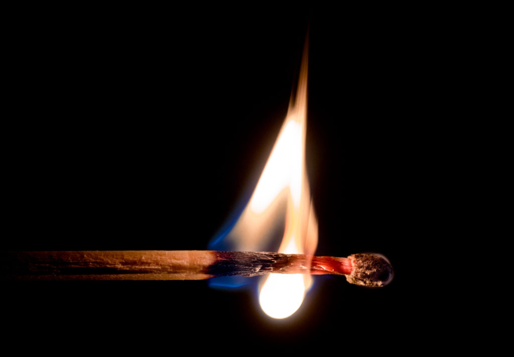 employee burnout: lit match burning down