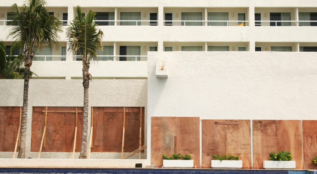 hurricane supply chain: windows boarded up on a hotel